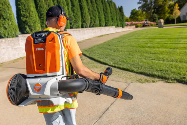 VS Landscape Group Landscaping technician using STIHL battery backpack blower for commercial property maintenance in Ottawa.